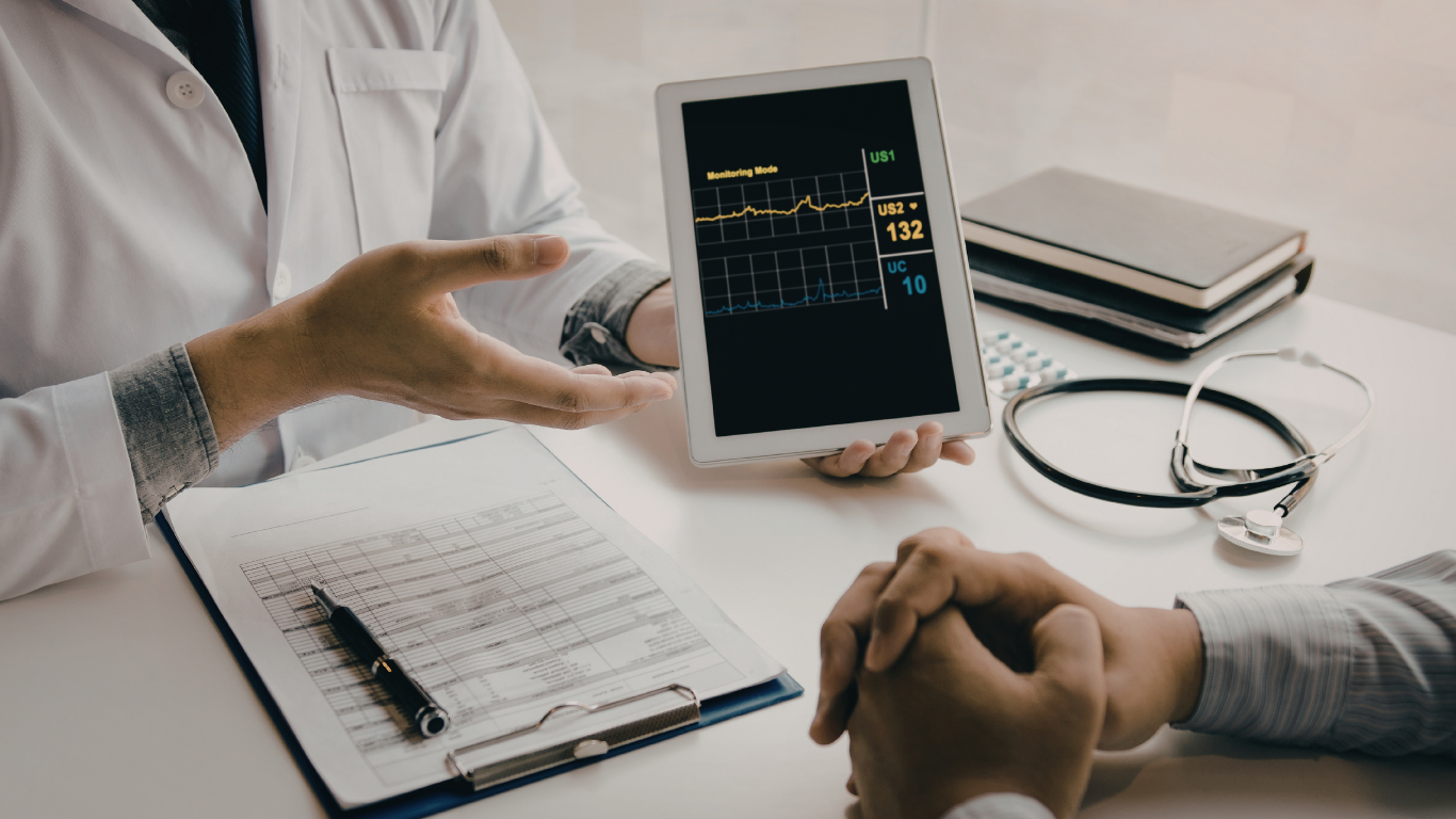 Vitality Health at Your Door physician reviewing remote monitoring data during a home visit